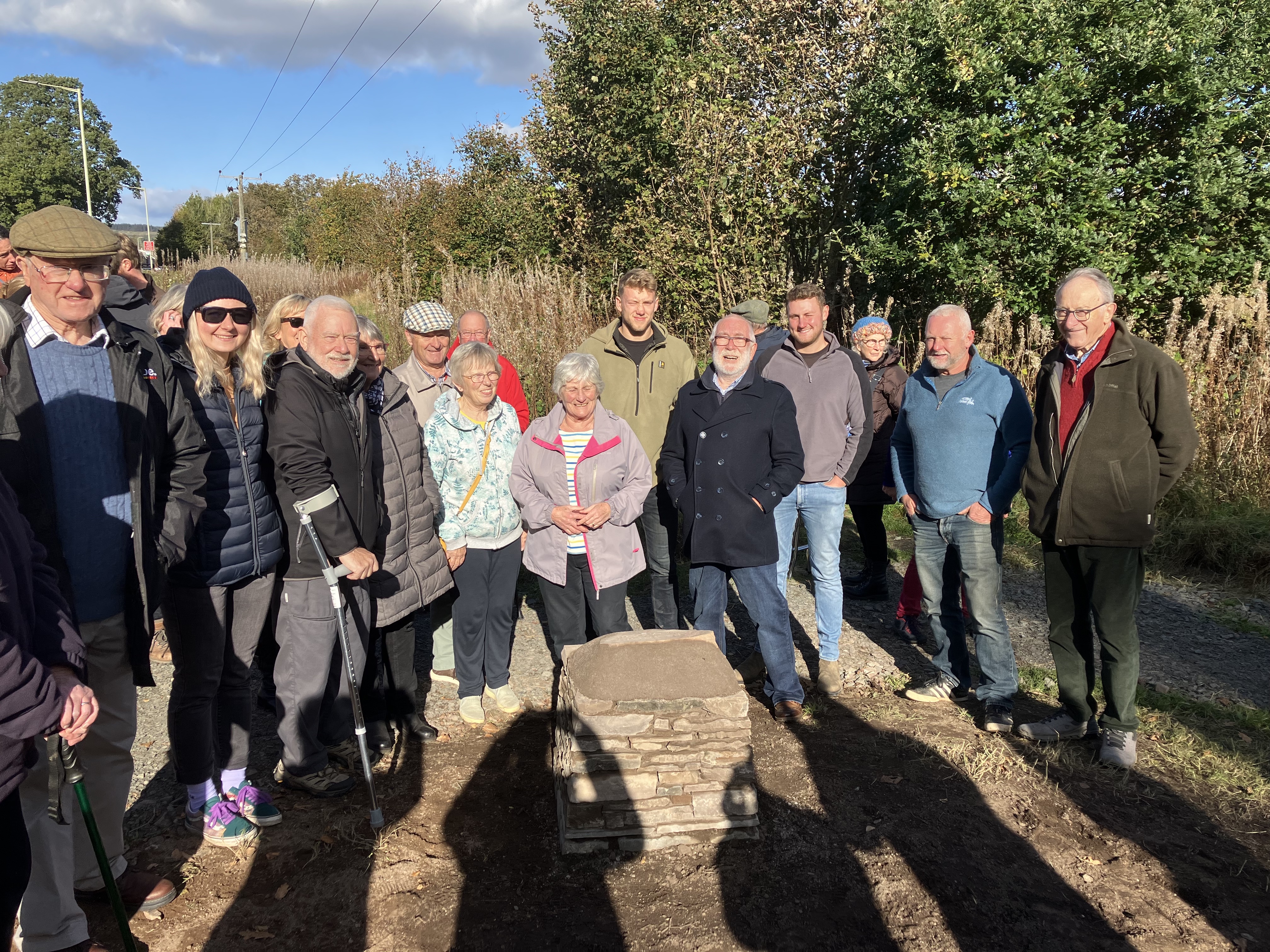 Members of Ardoch in Bloom, contractor Struan Donaldson and team, and villagers from Braco and Greenloaning celebrate the unveiling of the cairn to mark the finish of the wall restoration project